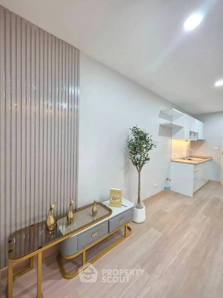 Modern open-plan living room with stylish decor and sleek kitchen area.
