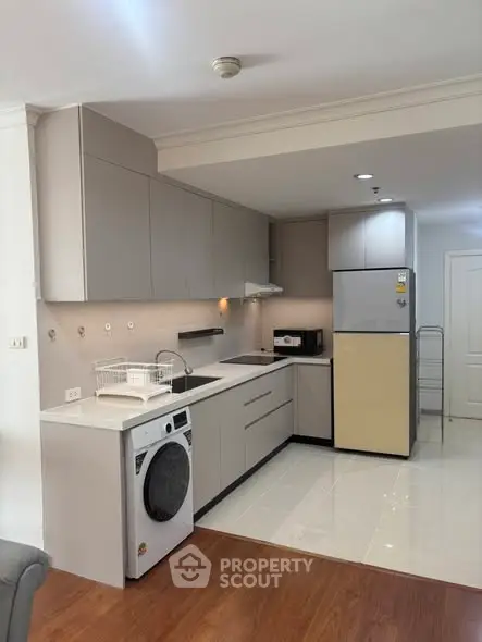 Modern kitchen with sleek cabinets and appliances in a stylish open layout.