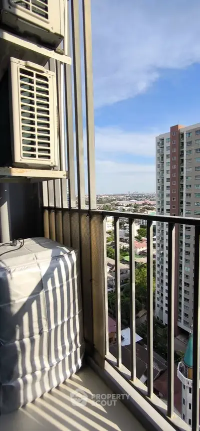 High-rise balcony with cityscape view and air conditioning unit