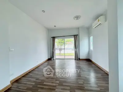 Spacious unfurnished room with large window and balcony access, perfect for customization.