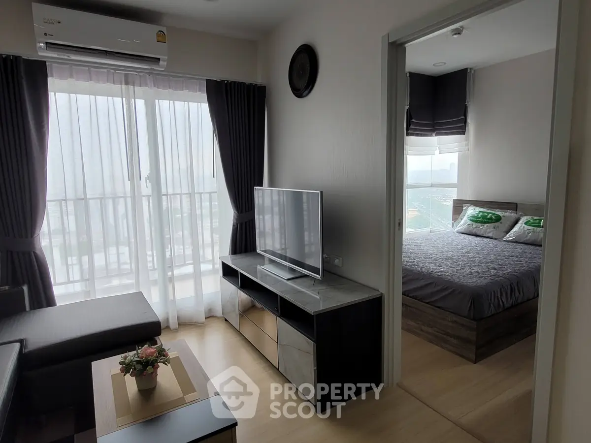 Modern apartment interior with cozy living room and bedroom, featuring large windows and stylish decor.