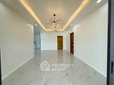 Spacious modern living room with elegant lighting and glossy tile flooring