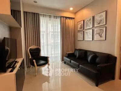 Elegant living room with modern decor, leather sofa, and stylish armchair, perfect for relaxation and entertainment.