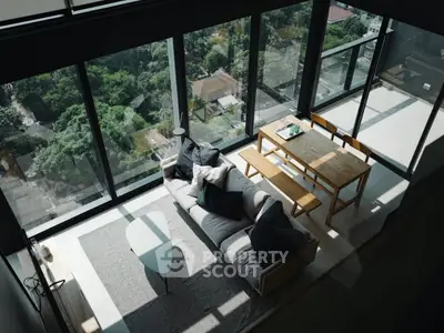 Stunning modern living room with floor-to-ceiling windows and breathtaking city view.
