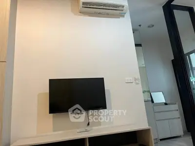 Modern living room with wall-mounted TV and air conditioning unit