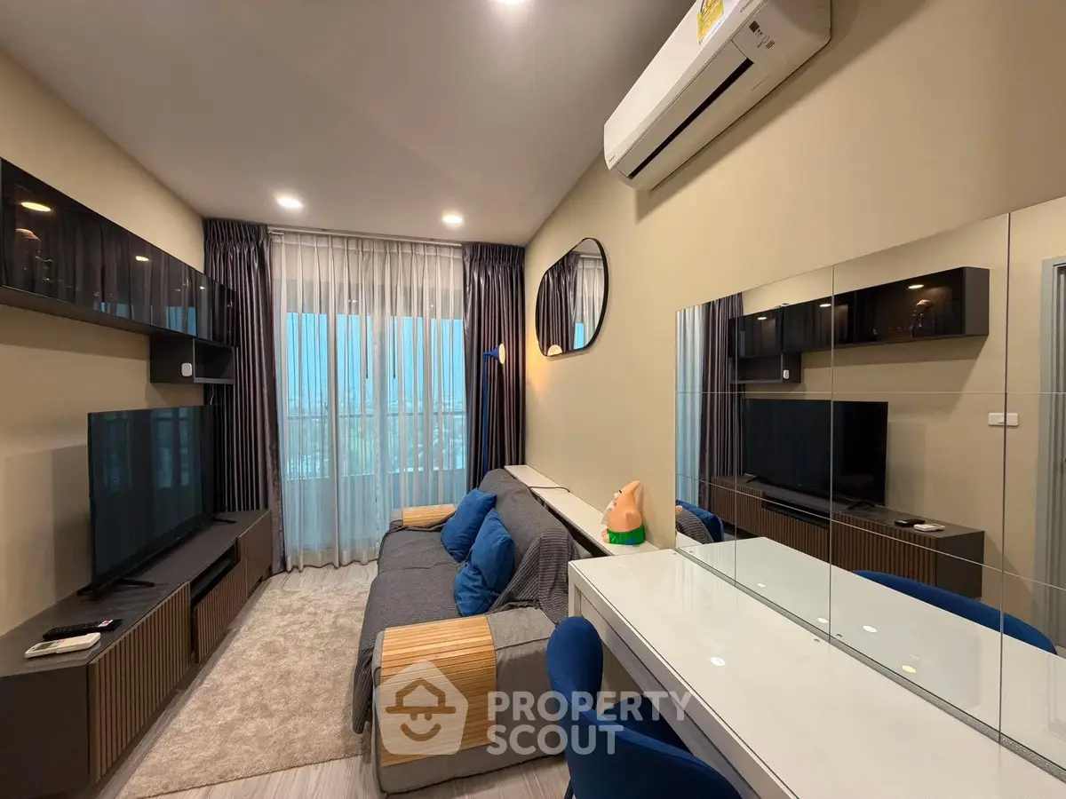 Modern living room with sleek furniture and large window, featuring a cozy sofa and stylish decor.
