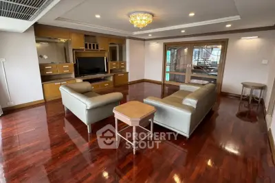 Spacious living room with elegant wooden flooring and modern furniture
