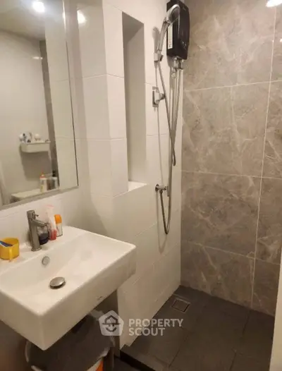 Modern bathroom with sleek shower and stylish sink in contemporary design.