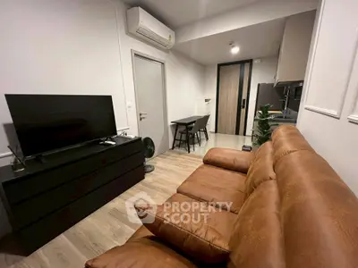Modern living room with leather sofa and sleek TV setup