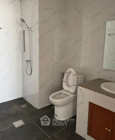 Modern bathroom with marble tiles and sleek fixtures