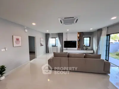 Spacious modern living room with sleek design and large windows for natural light.