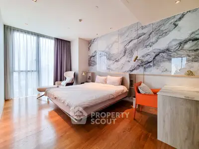 Luxurious modern bedroom with marble accent wall and elegant furnishings