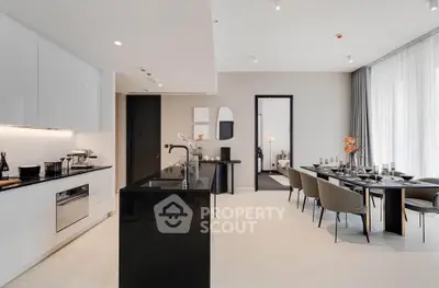 Luxurious open-plan kitchen and dining area with modern decor and sleek finishes.