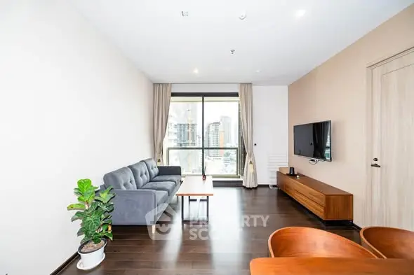 Modern living room with city view, sleek furniture, and natural light.
