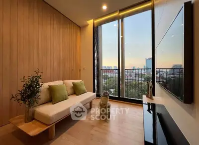 Modern living room with large windows and city view, featuring stylish decor and wooden accents.