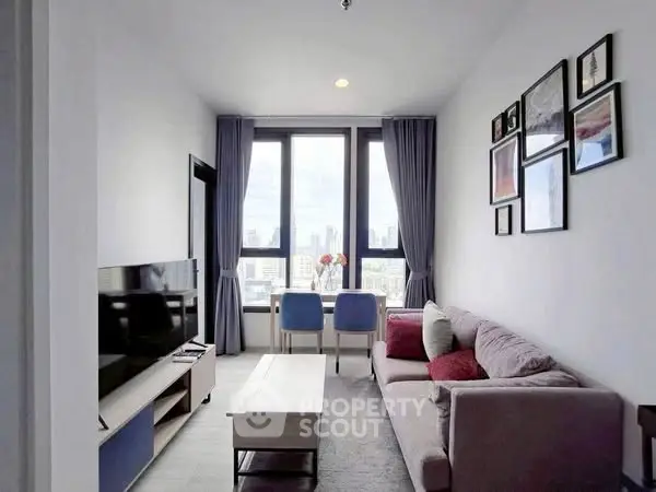 Modern living room with city view, stylish decor, and natural light.