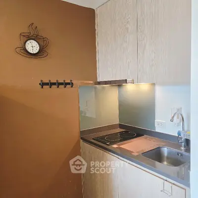 Modern compact kitchen with sleek design and induction cooktop