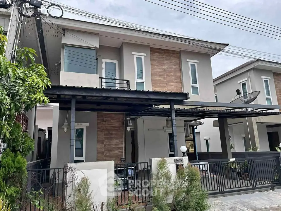 Modern two-story house with sleek design and spacious front yard