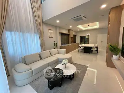 Spacious modern living room with elegant decor and open dining area