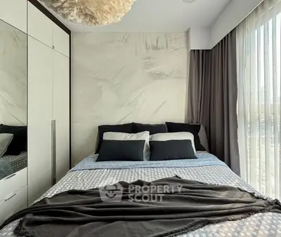 Cozy modern bedroom with stylish decor and ample natural light