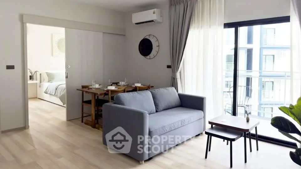 Modern living room with sliding doors and balcony view in stylish apartment