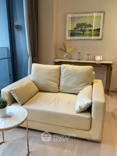 Elegant living room with plush beige sofa and stylish decor, perfect for modern urban living.