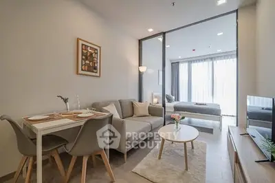 Modern open-plan living room and bedroom with stylish decor and natural light.