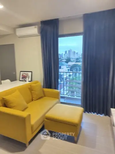 Modern living room with yellow sofa and city view from window