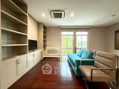 Spacious living room with modern furniture and large windows offering natural light.