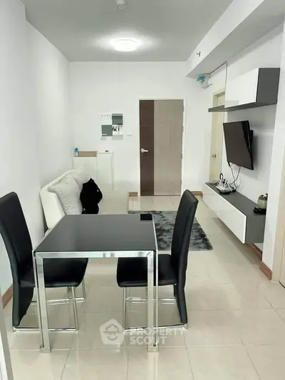 Modern living room with sleek furniture and wall-mounted TV