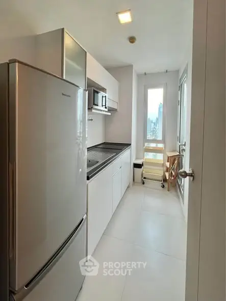 Modern kitchen with sleek appliances and city view, perfect for urban living.