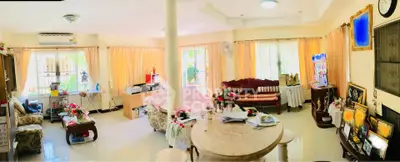 Spacious living room with elegant decor and abundant natural light, perfect for family gatherings and relaxation.