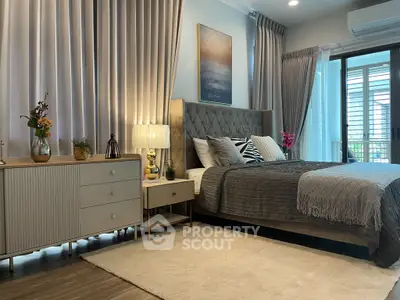 Luxurious bedroom with elegant decor and large windows for natural light