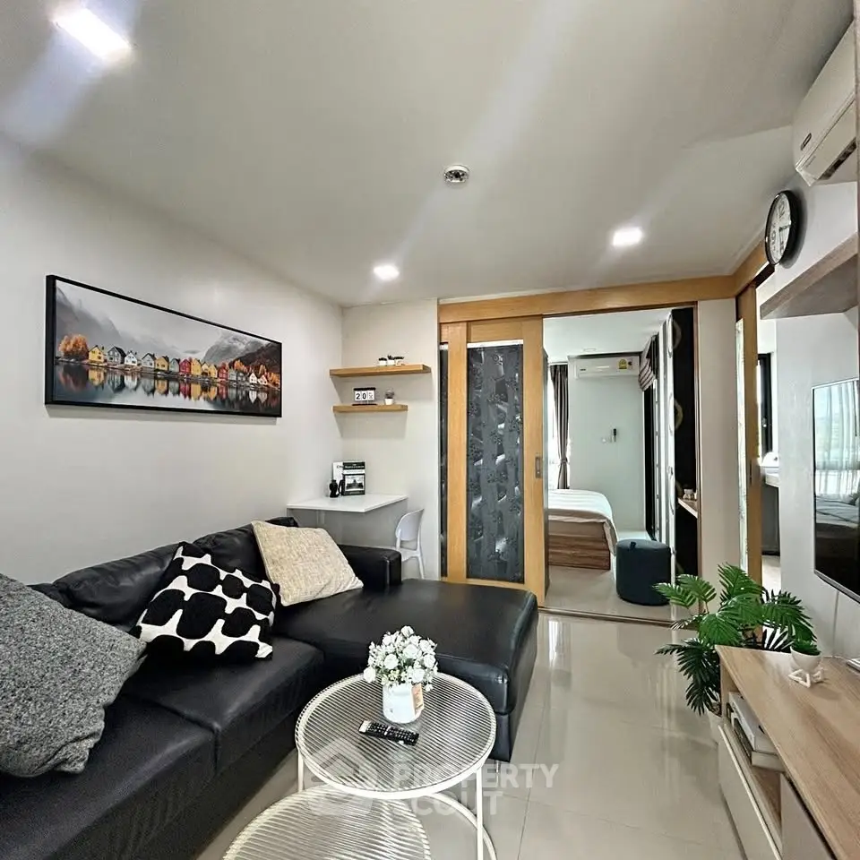 Modern living room with sleek black sofa and stylish decor