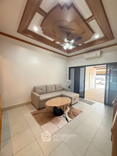 Spacious living room with modern ceiling design and cozy sofa