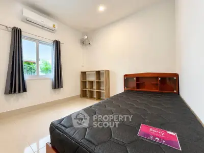 Spacious bedroom with modern furnishings and natural light