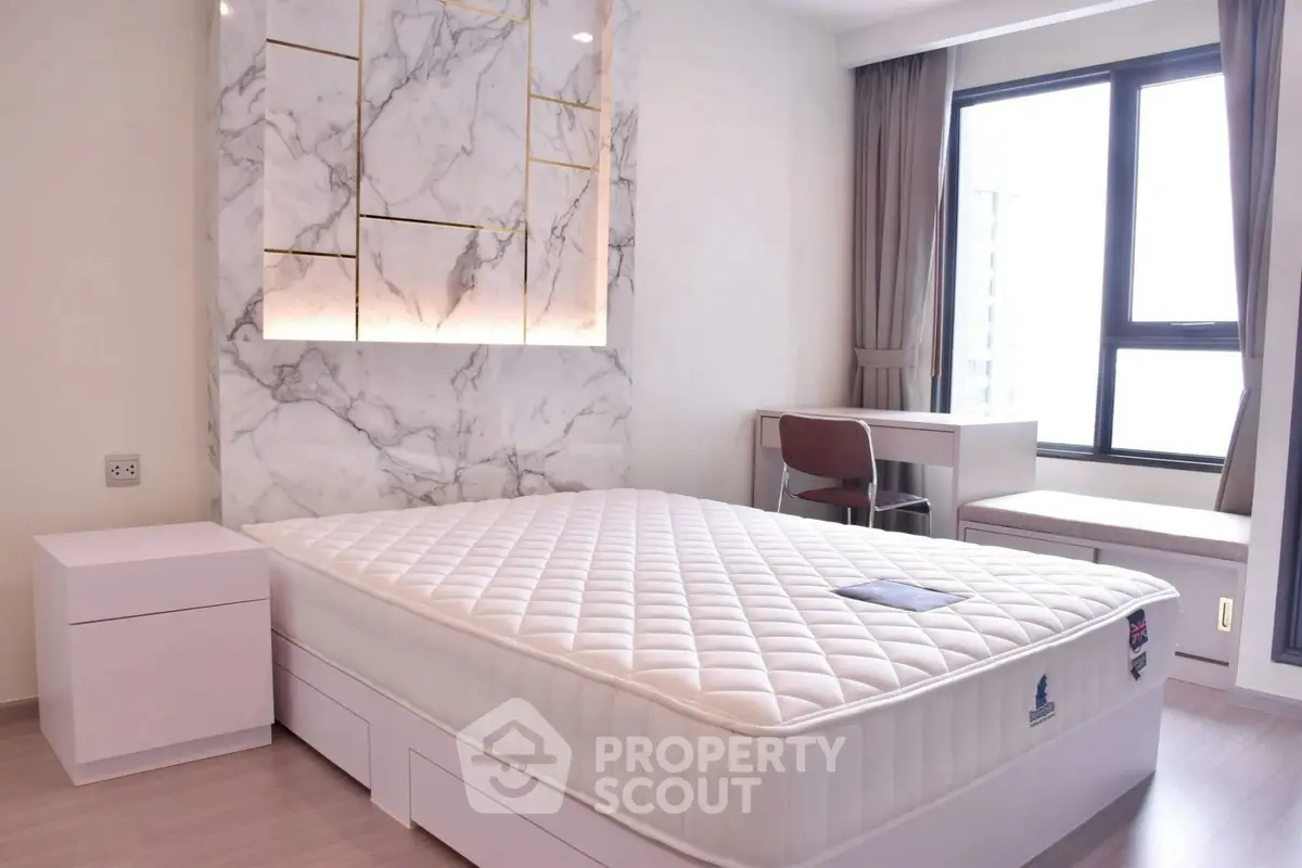 Modern bedroom with marble accent wall and large window view