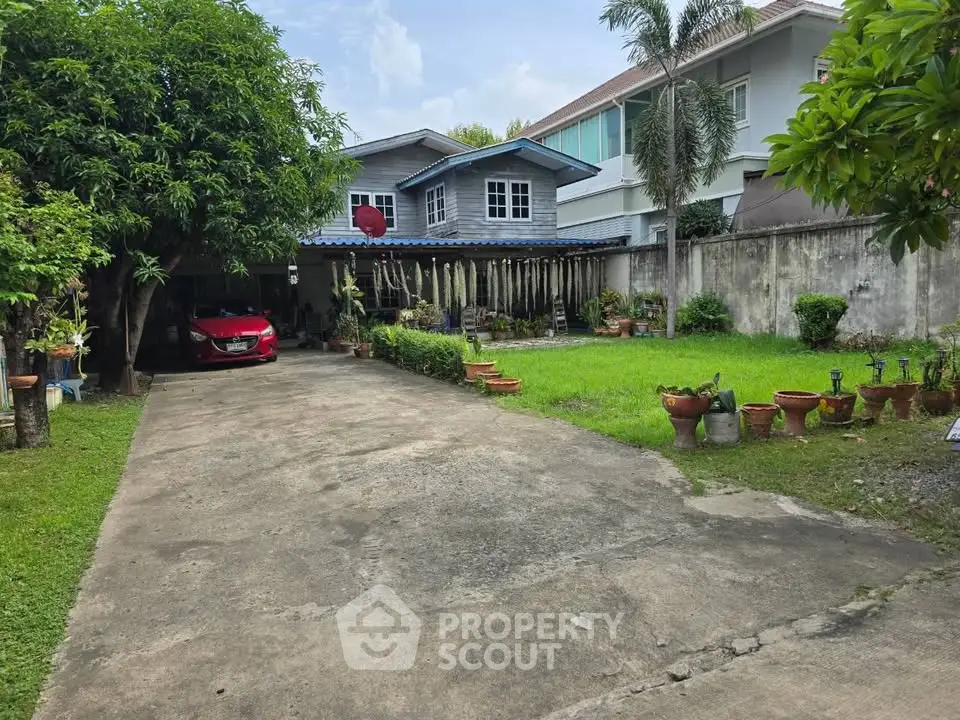 Charming suburban home with spacious driveway and lush garden, perfect for family living.