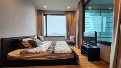 Spacious bedroom with city view and modern decor