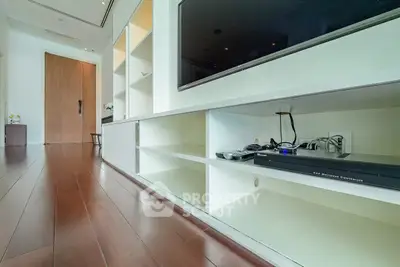 Modern living room with sleek TV unit and wooden flooring