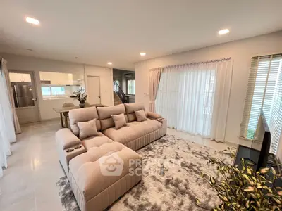 Spacious modern living room with plush sectional sofa and open kitchen layout