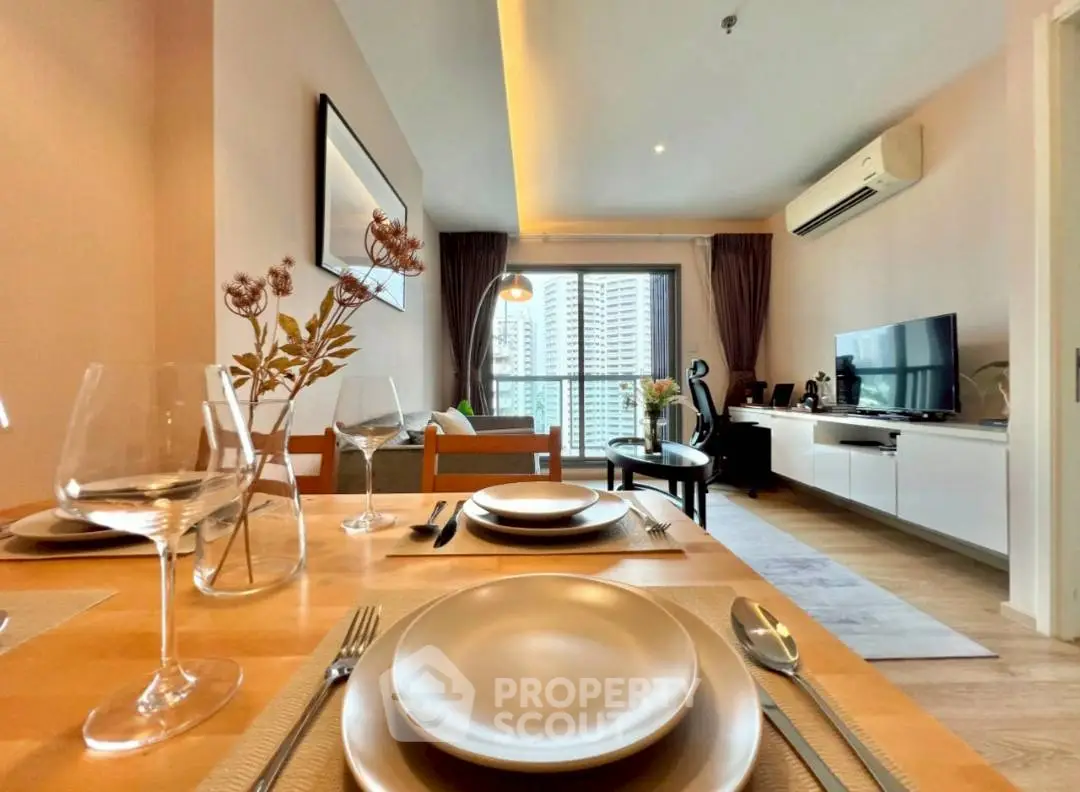 Modern living room with dining area and city view, featuring elegant decor and natural light.