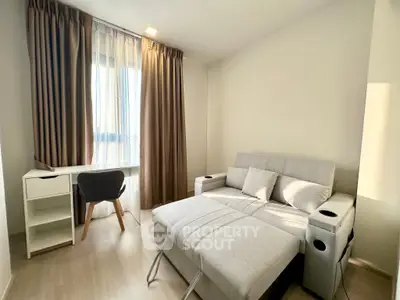 Modern living room with stylish sofa bed and workspace near window