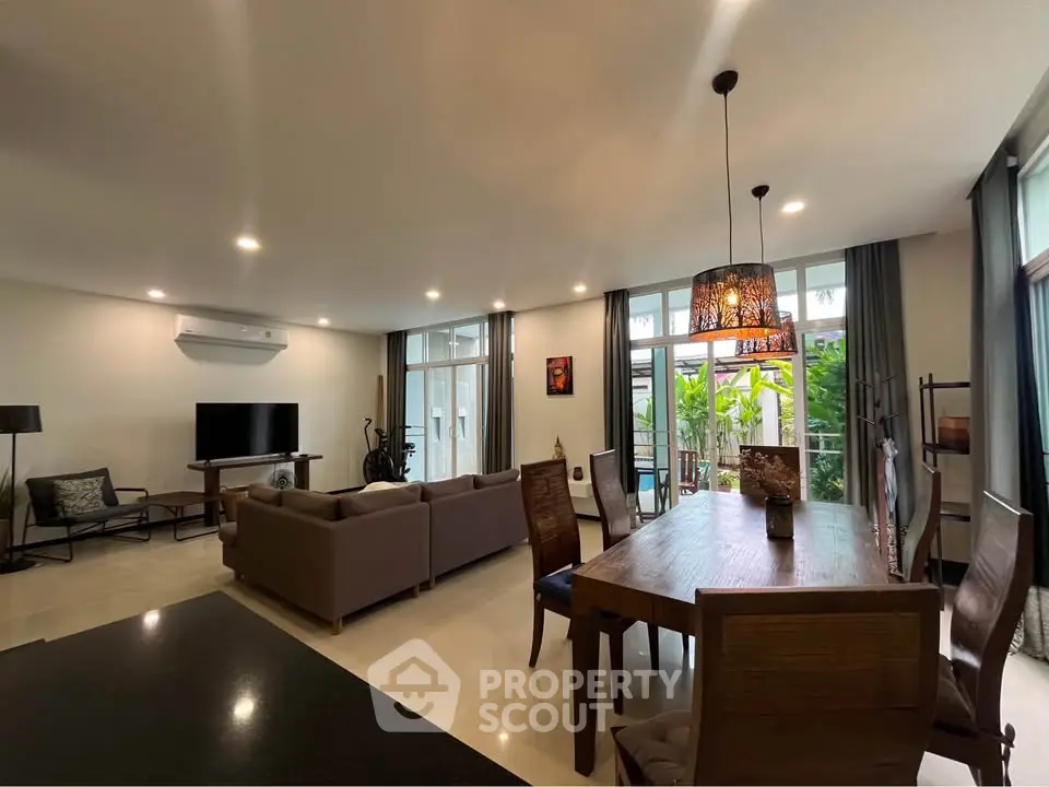 Spacious modern living room with elegant dining area and large windows