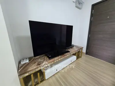 Modern living room with sleek TV setup on stylish marble console