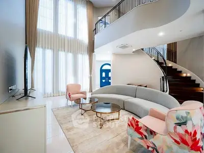 Luxurious modern living room with high ceilings and elegant staircase
