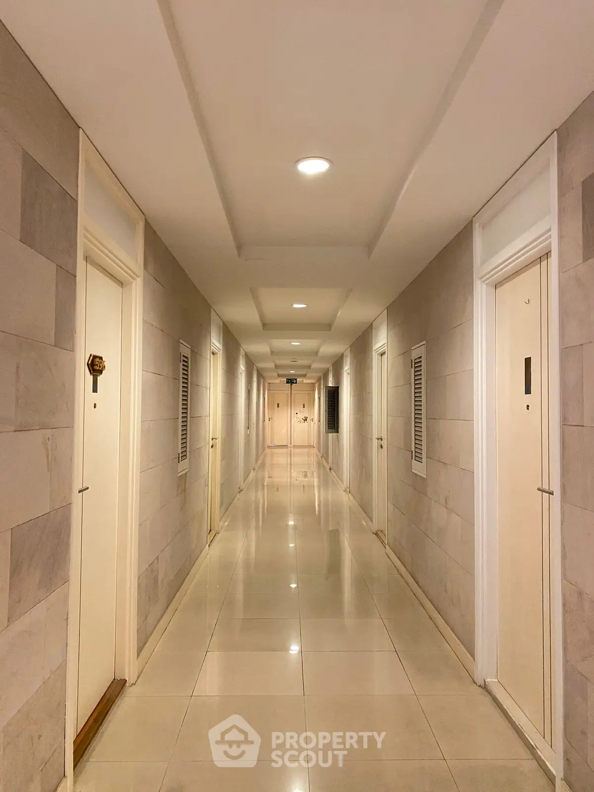 Spacious and well-lit apartment hallway with modern design and sleek finishes.