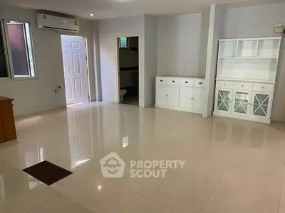 Spacious unfurnished living room with air conditioning and built-in cabinets