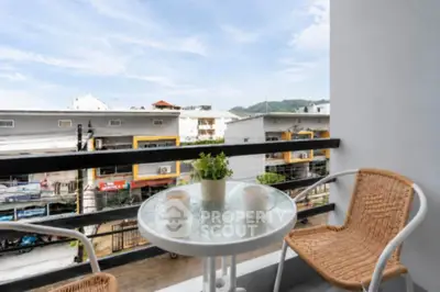 Charming balcony with cozy seating and scenic urban view, perfect for relaxation.