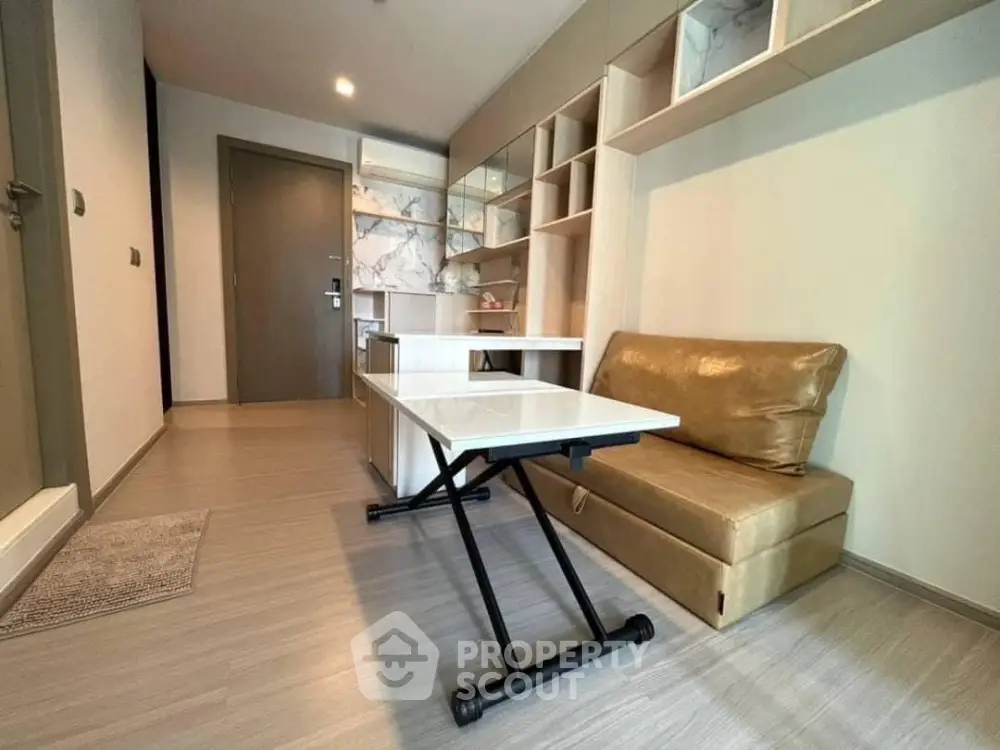 Modern studio apartment with convertible furniture and stylish storage solutions